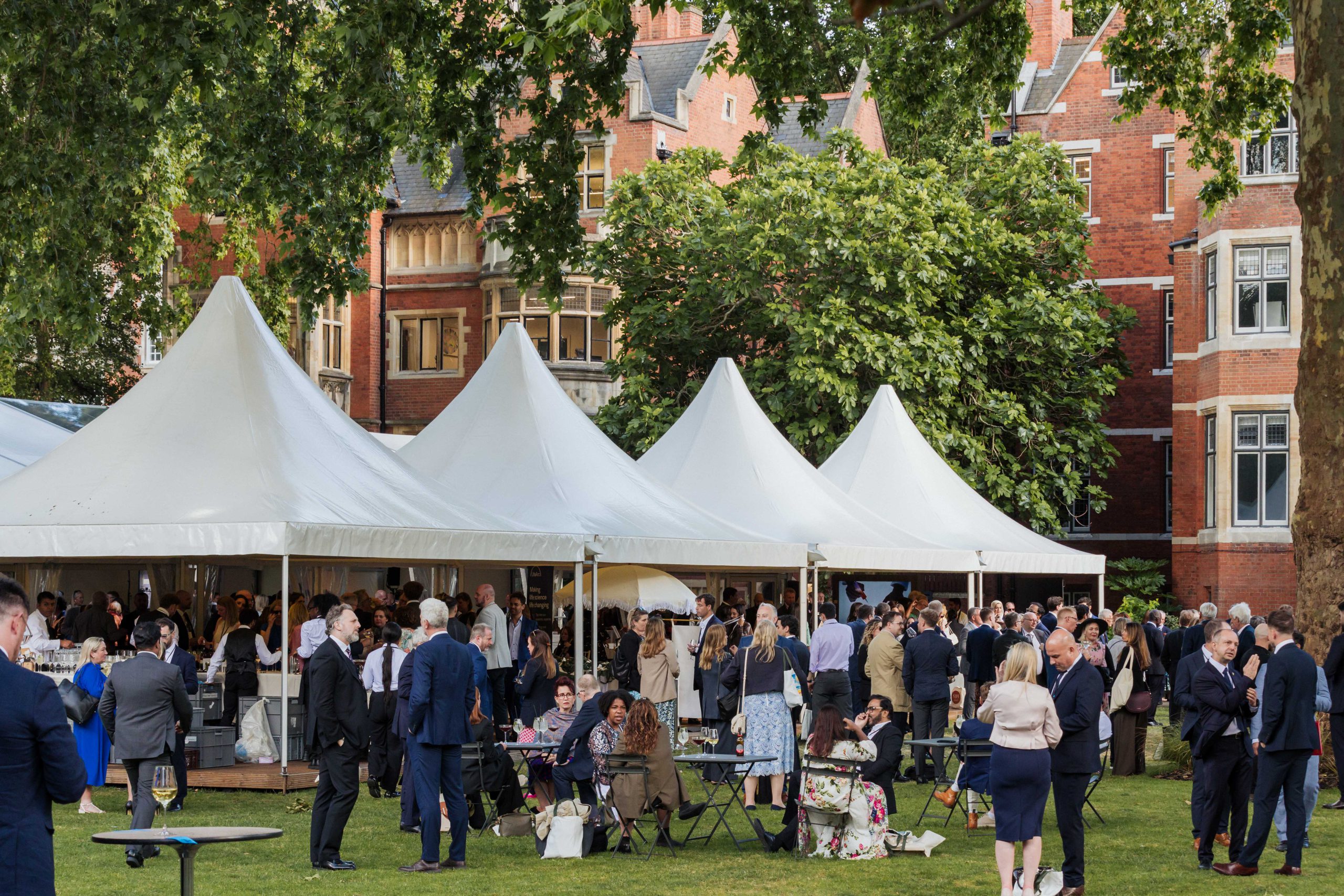 Guests gathered at an outdoor SJH Events reception.