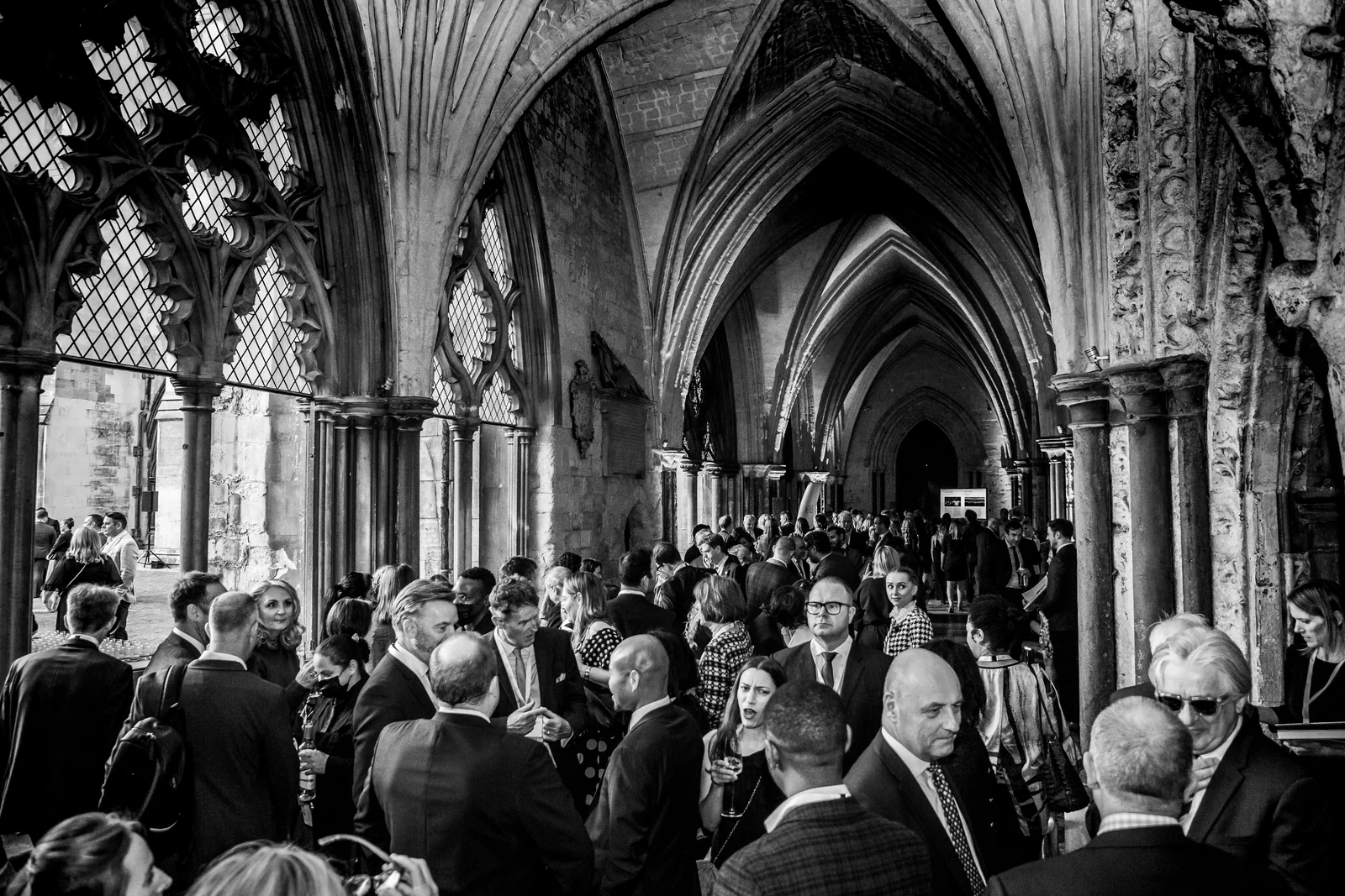 A reception beneath a vaulted ceiling, in black and white