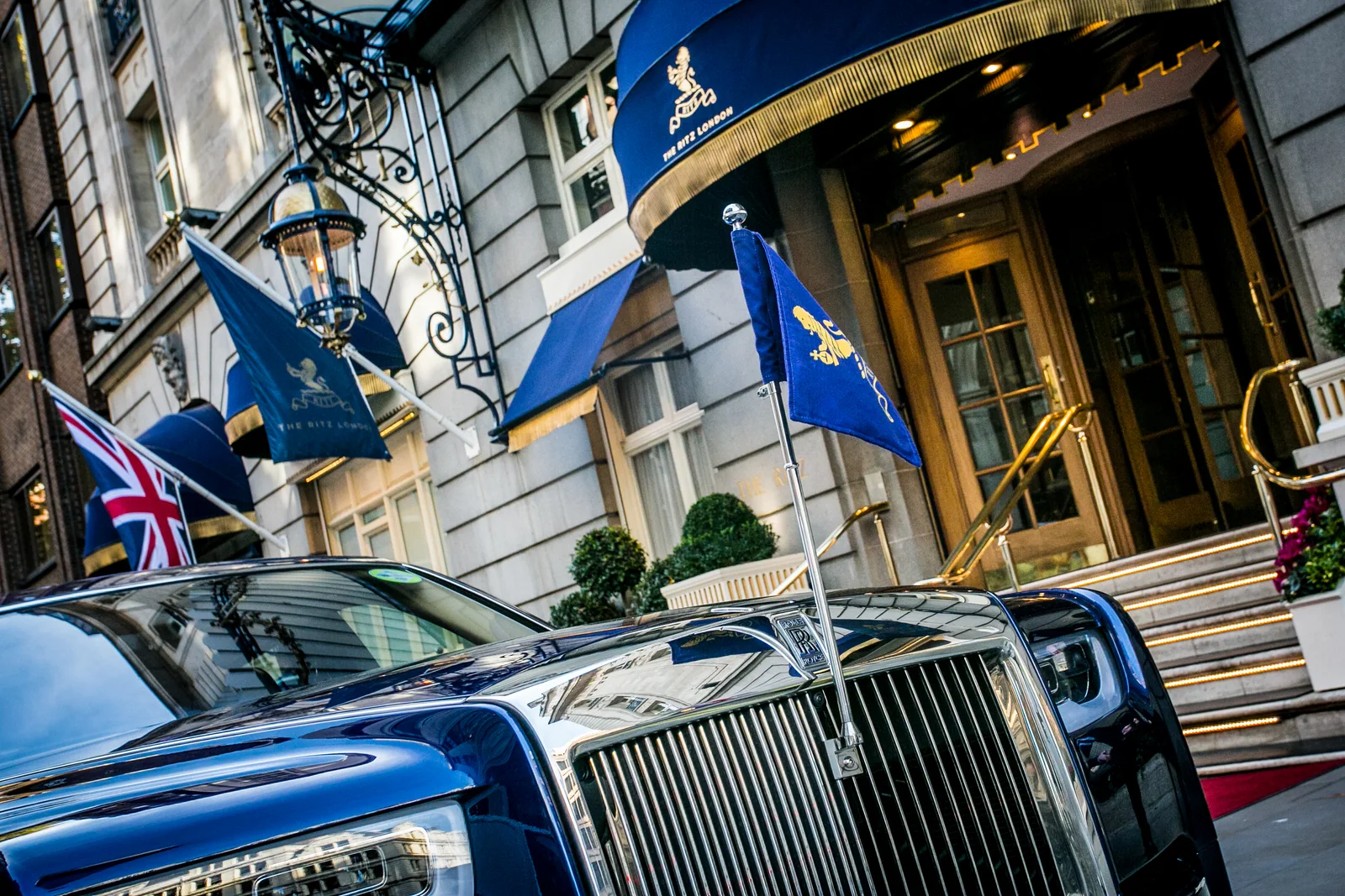A car arriving beneath flags at a London hotel