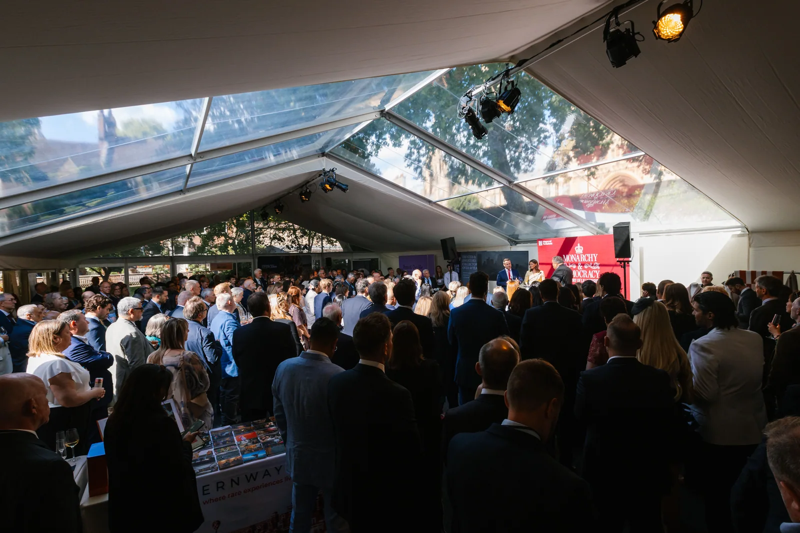 Guests gathered beneath a marquee in College Garden