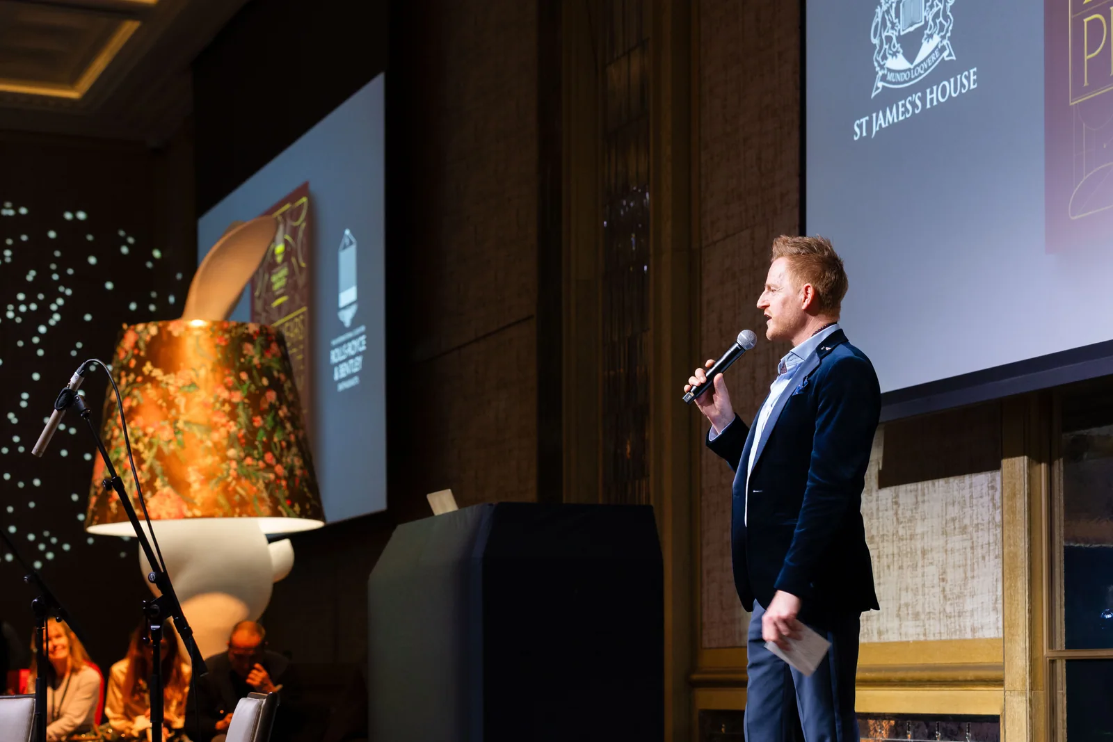 A speaker on stage at the 100 Years of the Phantom event