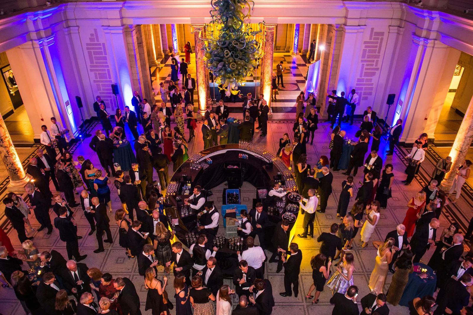An evening gathering in a richly lit historic venue