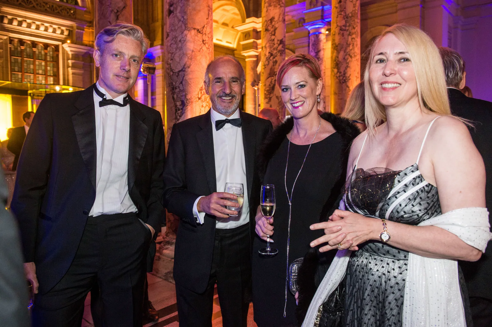 Guests in conversation at a black-tie event