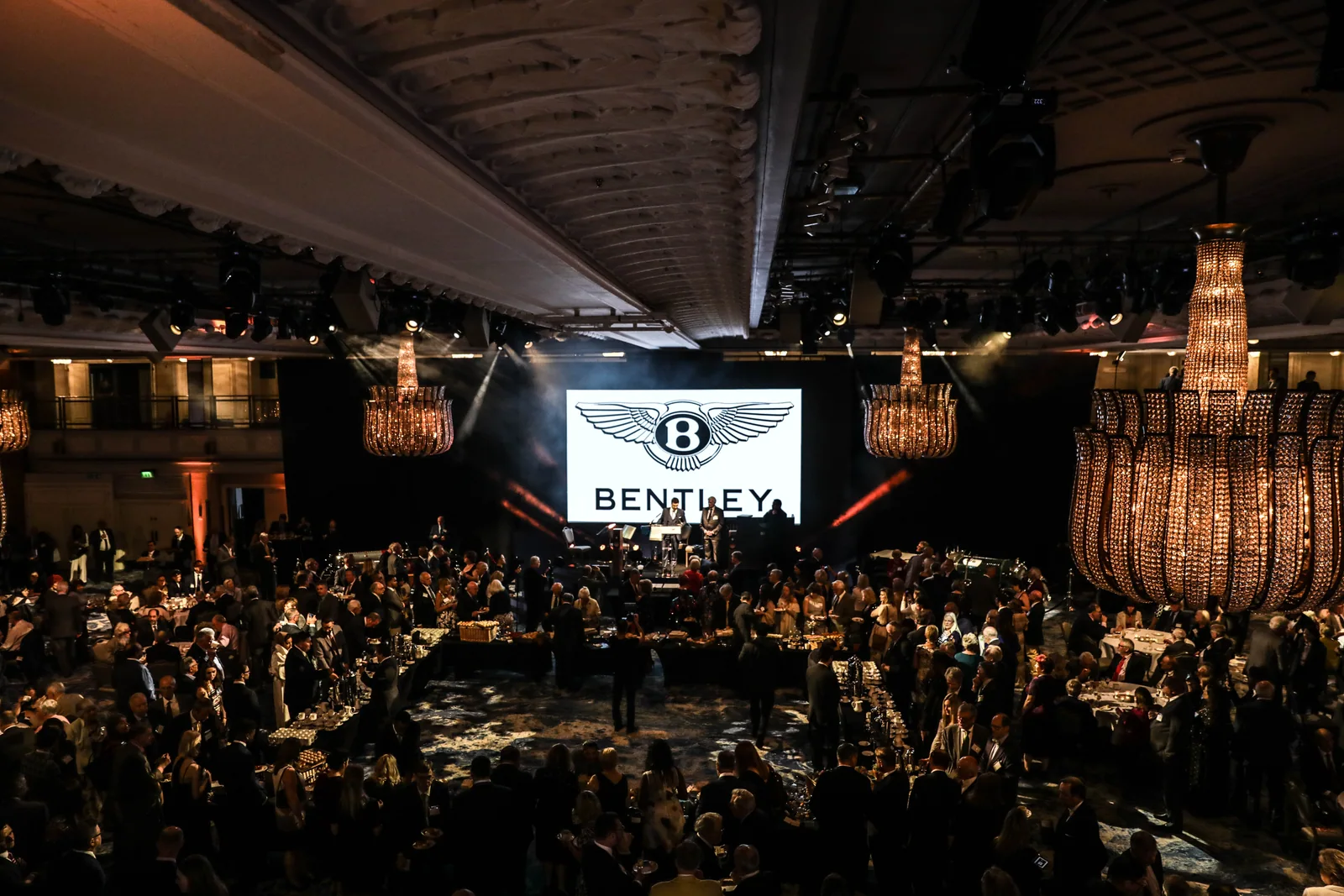 An audience and stage at a large evening event