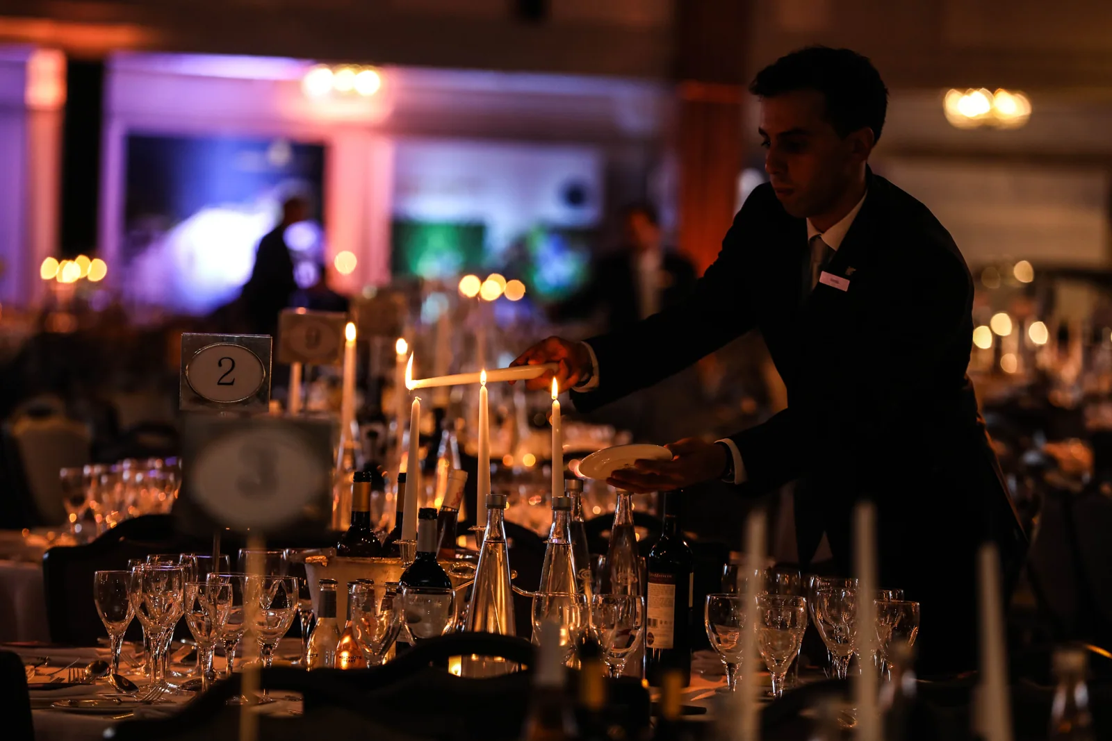 A team member serving drinks during an evening reception