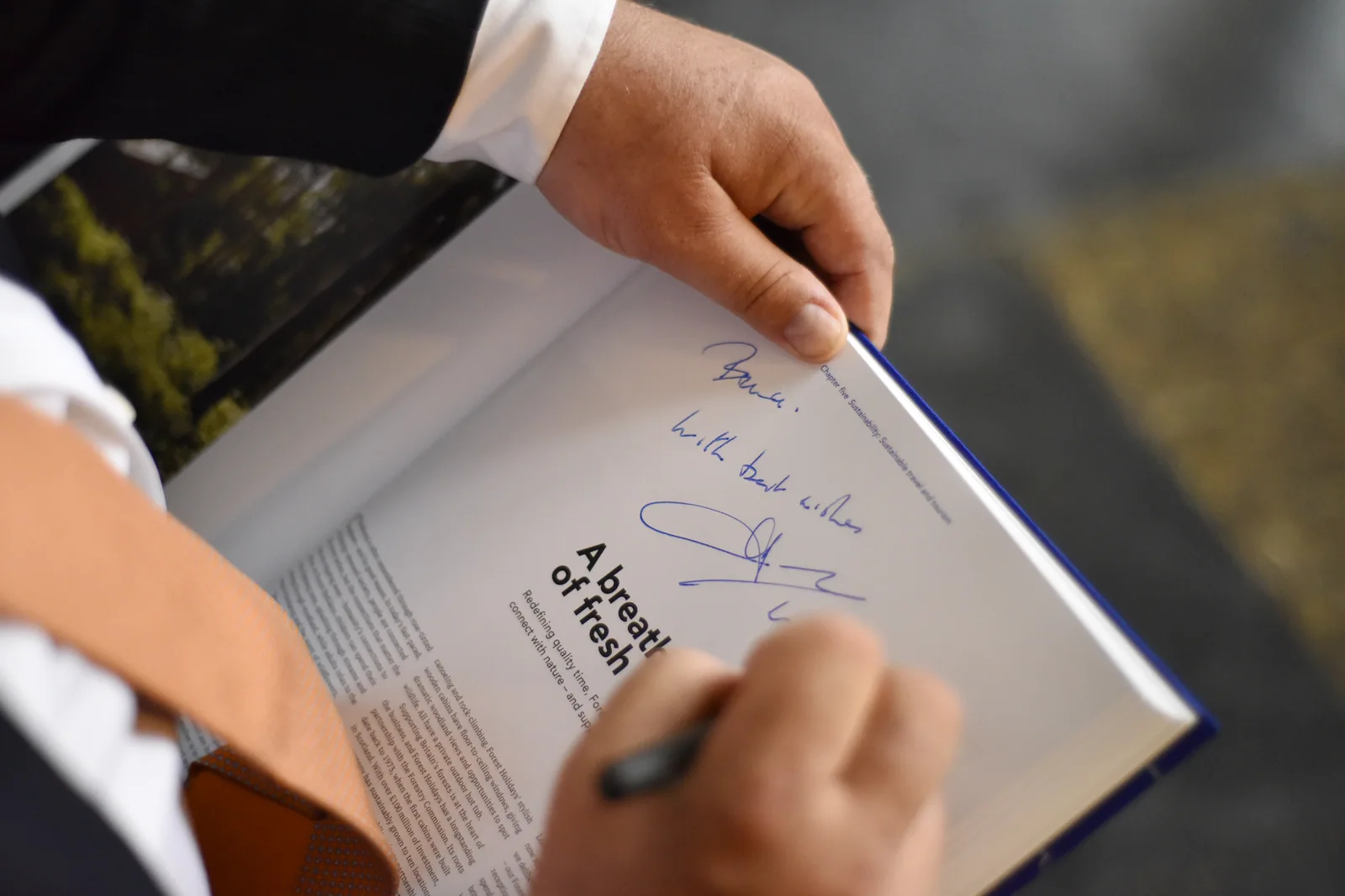 A personal inscription being added to a publication